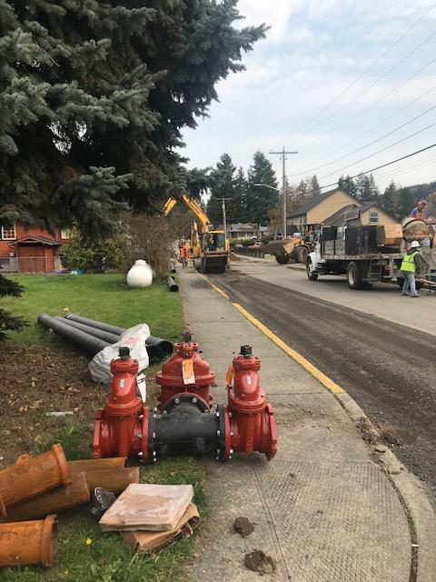 construction and sewer pipes next to a road